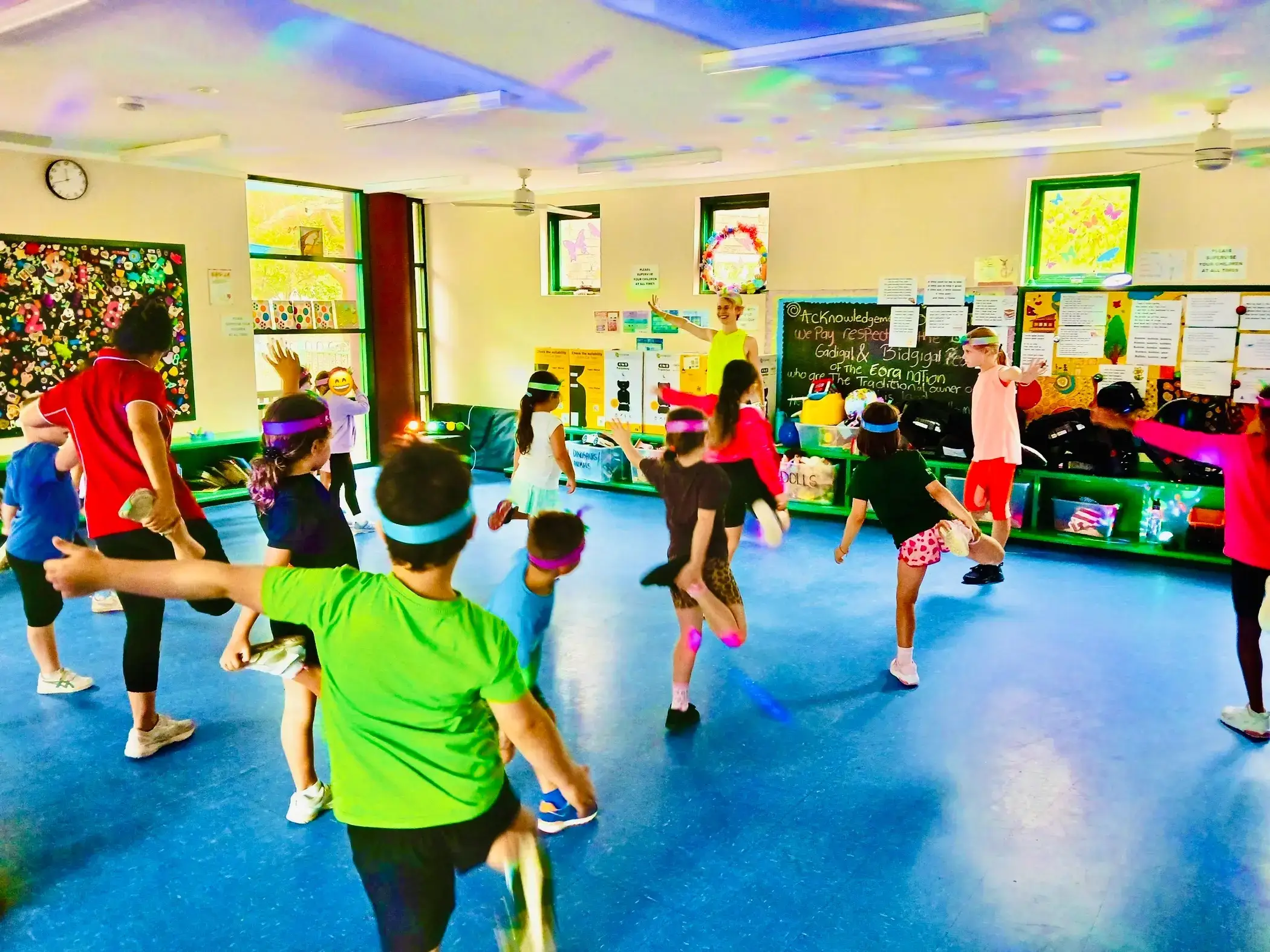 Children kicking and jumping in time during a vacation care dance routine